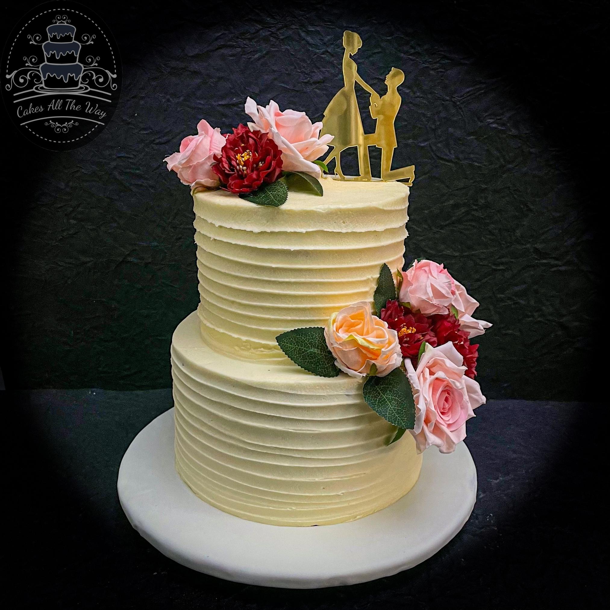 Photo of 2 tier floral cake with engagement ring cake topper